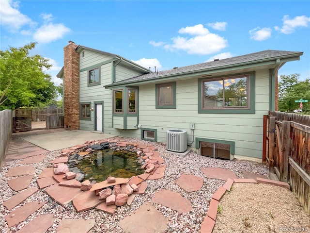 1460 Belmont Dr, Longmont, CO 80503 - back of house with a patio area, a fenced backyard, and a chimney