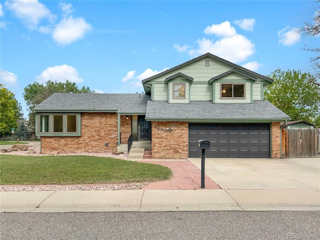 1460 Belmont Dr, Longmont, CO 80503 - split level home featuring brick siding, a garage, a shingled roof, and concrete driveway