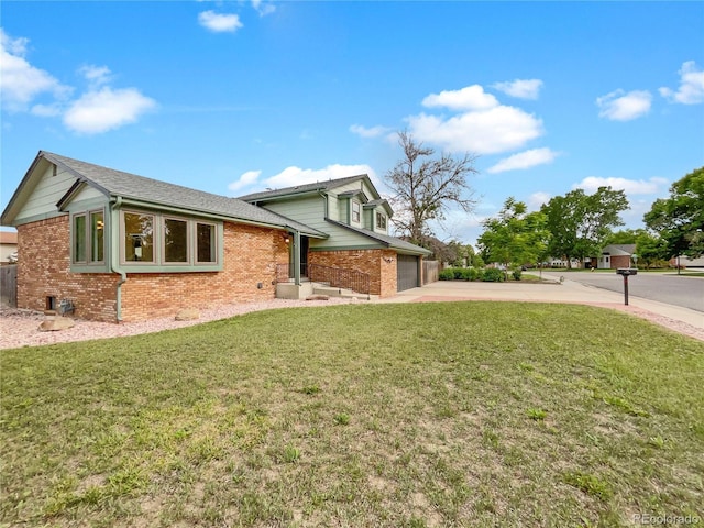 1460 Belmont Dr, Longmont, CO 80503 - view of property exterior featuring brick siding, driveway, a garage, and a yard