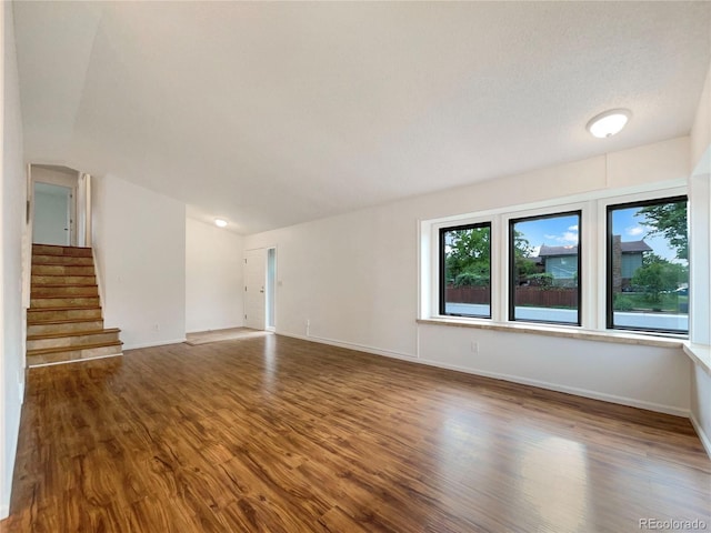 1460 Belmont Dr, Longmont, CO 80503 - unfurnished living room featuring wood finished floors and stairs