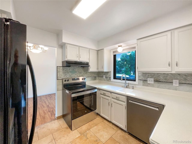 1460 Belmont Dr, Longmont, CO 80503 - kitchen with stainless steel appliances, under cabinet range hood, light countertops, and decorative backsplash
