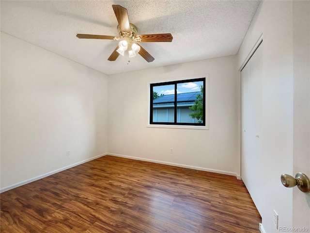 1460 Belmont Dr, Longmont, CO 80503 - unfurnished room with wood finished floors, a textured ceiling, and ceiling fan