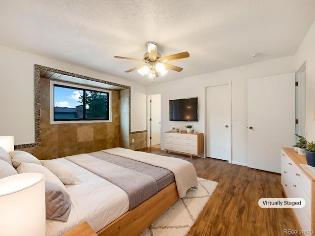 1460 Belmont Dr, Longmont, CO 80503 - bedroom featuring dark wood-style flooring and ceiling fan