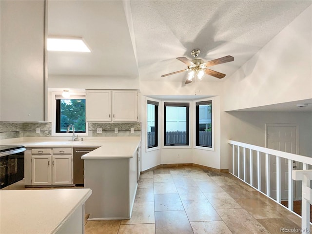 1460 Belmont Dr, Longmont, CO 80503 - kitchen with appliances with stainless steel finishes, tasteful backsplash, a ceiling fan, light countertops, and a peninsula
