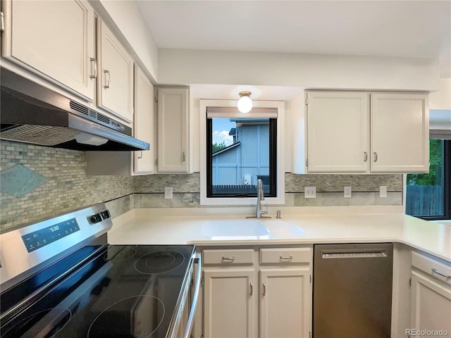1460 Belmont Dr, Longmont, CO 80503 - kitchen featuring stainless steel appliances, backsplash, under cabinet range hood, and light countertops