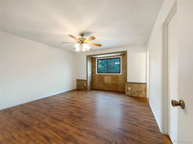 1460 Belmont Dr, Longmont, CO 80503 - spare room with wood finished floors, a textured ceiling, ceiling fan, and wainscoting
