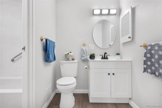 bathroom with vanity, hardwood / wood-style floors, and toilet