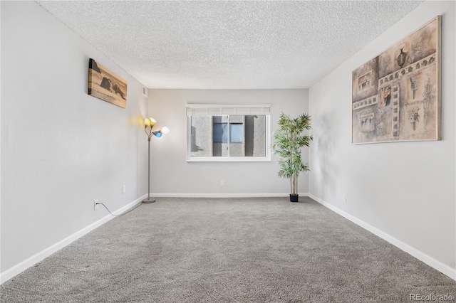 unfurnished room with carpet floors and a textured ceiling