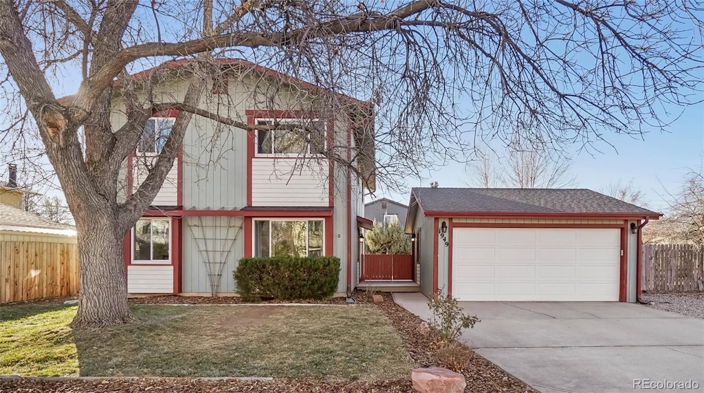 view of front of house with a garage and a front lawn