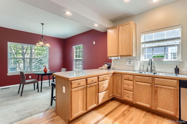 511 Noel Ave, Longmont, CO 80501 - kitchen with a sink, light countertops, a peninsula, light wood-type flooring, and recessed lighting