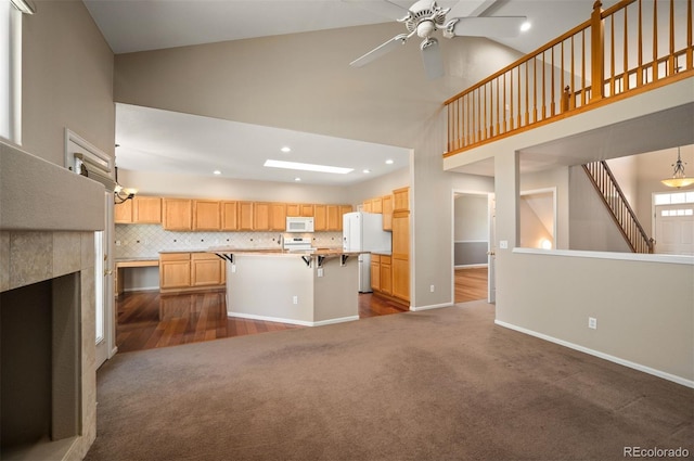 15577 Greenstone Cir, Parker, CO 80134 - unfurnished living room featuring high vaulted ceiling, a ceiling fan, dark colored carpet, dark wood-type flooring, and recessed lighting