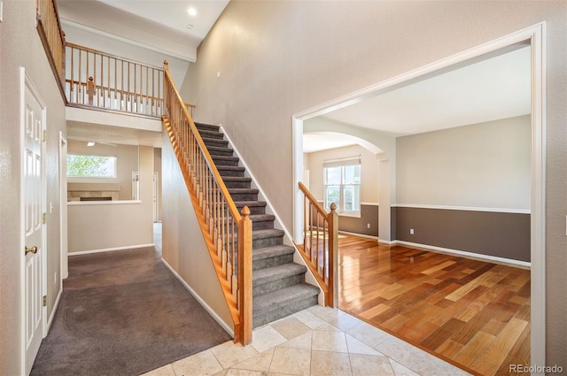 15577 Greenstone Cir, Parker, CO 80134 - stairway with plenty of natural light, arched walkways, and wood finished floors