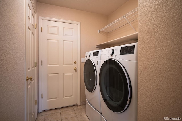 15577 Greenstone Cir, Parker, CO 80134 - washroom with washing machine and dryer, light tile patterned floors, and a textured wall