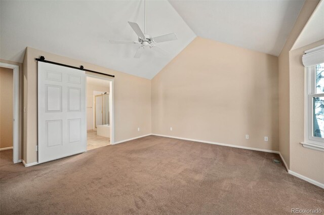 15577 Greenstone Cir, Parker, CO 80134 - unfurnished bedroom featuring lofted ceiling, carpet, a barn door, ensuite bath, and a ceiling fan