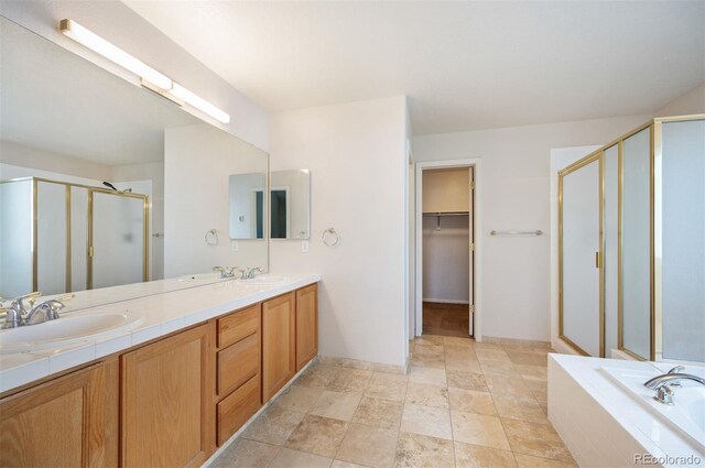 15577 Greenstone Cir, Parker, CO 80134 - bathroom with a stall shower, double vanity, a bath, a walk in closet, and stone finish flooring