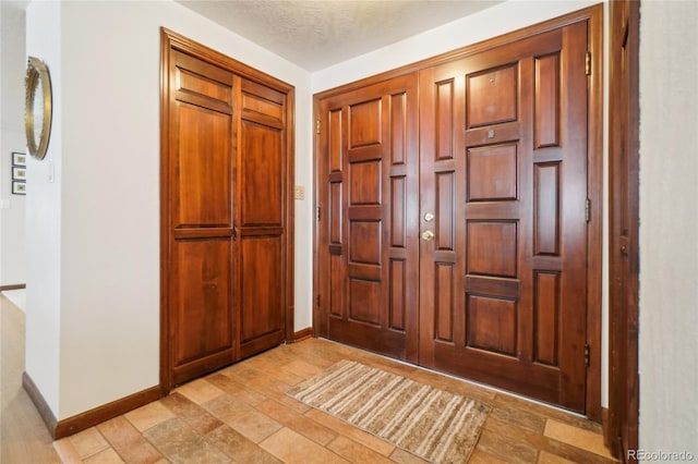 entrance foyer with a textured ceiling