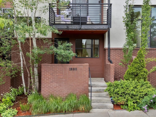 1880 W 32nd Ave, Denver, CO 80211 - view of front of house with a balcony, stucco siding, and brick siding