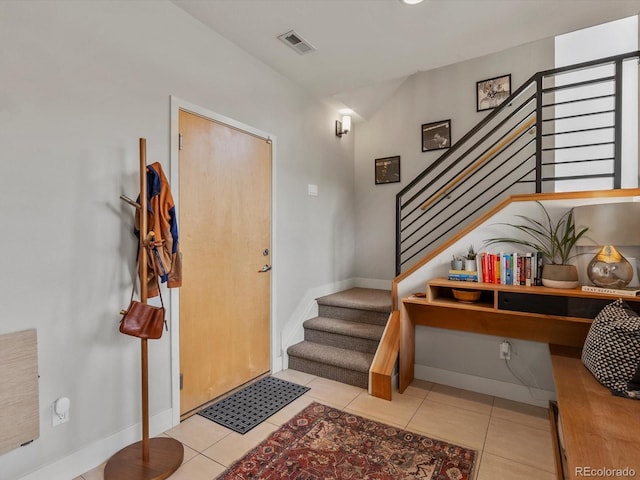 1880 W 32nd Ave, Denver, CO 80211 - foyer entrance with baseboards, stairs, and light tile patterned floors