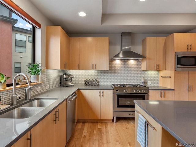 1880 W 32nd Ave, Denver, CO 80211 - kitchen featuring wall chimney range hood, appliances with stainless steel finishes, a sink, tasteful backsplash, and light wood-style floors