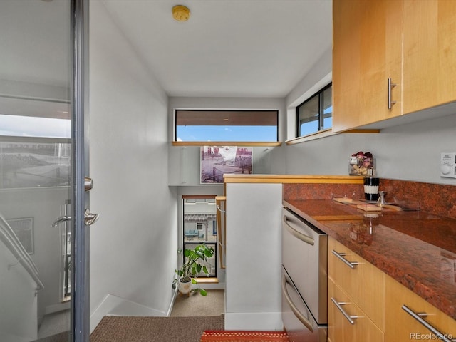 1880 W 32nd Ave, Denver, CO 80211 - kitchen featuring baseboards, dark stone countertops, and carpet