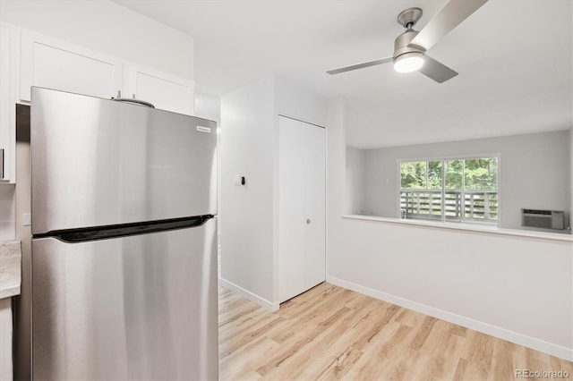 660 S Alton Way Unit 12C, Denver, CO 80247 - kitchen with freestanding refrigerator, light wood finished floors, white cabinetry, a ceiling fan, and light countertops