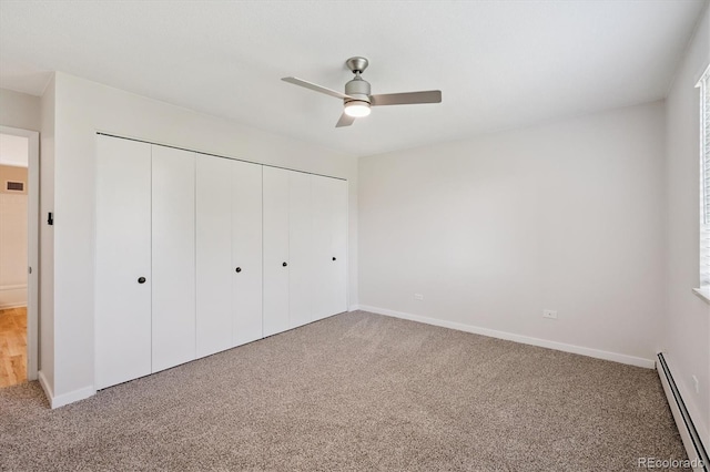 660 S Alton Way Unit 12C, Denver, CO 80247 - unfurnished bedroom featuring a baseboard heating unit, a closet, carpet flooring, and a ceiling fan
