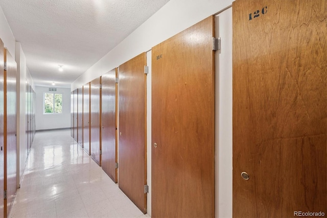660 S Alton Way Unit 12C, Denver, CO 80247 - hallway featuring a textured ceiling