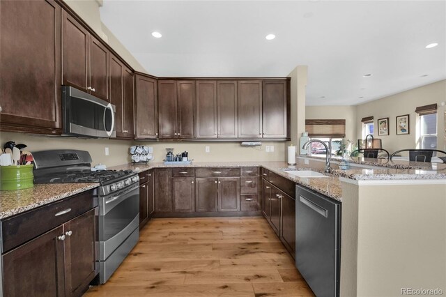 6203 Adamants Dr, Colorado Springs, CO 80924 - kitchen with appliances with stainless steel finishes, light wood finished floors, a sink, and plenty of natural light