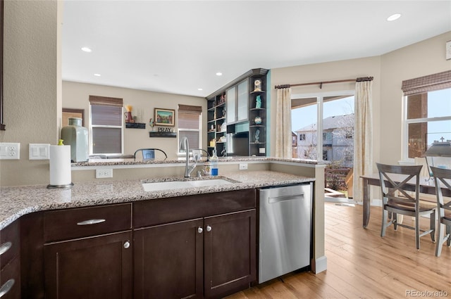 6203 Adamants Dr, Colorado Springs, CO 80924 - kitchen with dark brown cabinetry, open shelves, light wood-style floors, stainless steel dishwasher, and a sink