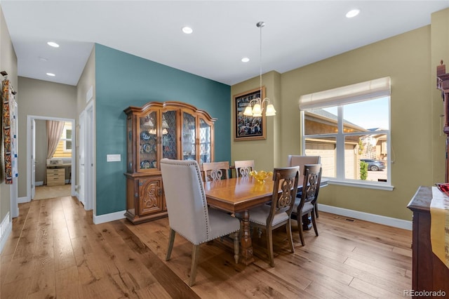 6203 Adamants Dr, Colorado Springs, CO 80924 - dining area with a chandelier, light wood-style floors, and a healthy amount of sunlight