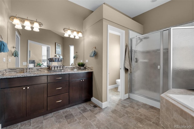 6203 Adamants Dr, Colorado Springs, CO 80924 - bathroom with a sink, toilet, stone finish floor, a shower stall, and double vanity