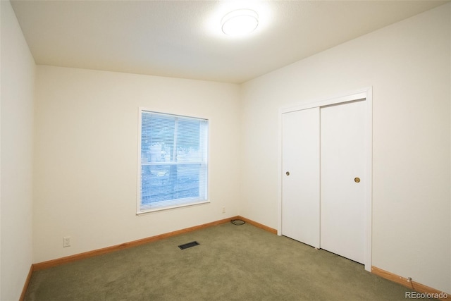 unfurnished bedroom featuring carpet flooring, visible vents, and baseboards