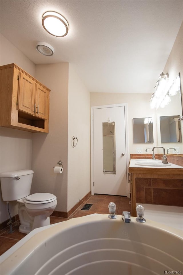 bathroom with a tub to relax in, visible vents, toilet, tile patterned floors, and vanity