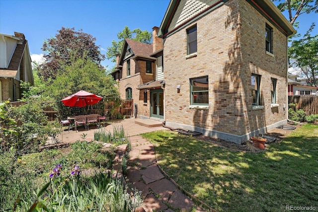 3764 Newton St, Denver, CO 80211 - back of property featuring brick siding and a patio