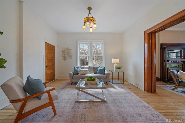 3764 Newton St, Denver, CO 80211 - living area featuring wood finished floors, a chandelier, and baseboards