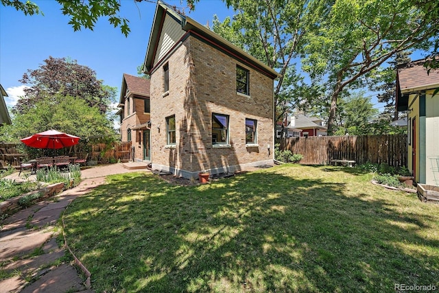 3764 Newton St, Denver, CO 80211 - back of house featuring brick siding and a patio area