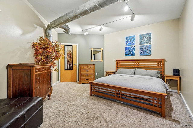 bedroom with track lighting, carpet flooring, ceiling fan, and baseboards