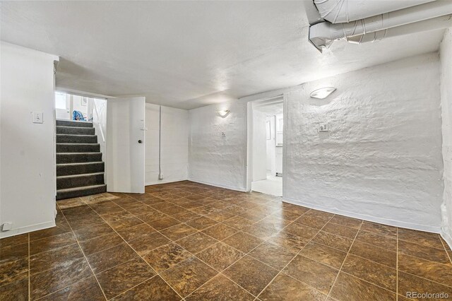 below grade area with stairway and baseboards