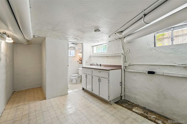 bathroom featuring toilet, tile patterned floors, and vanity
