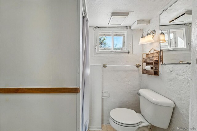 bathroom featuring toilet and a shower