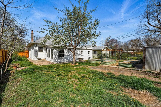 view of yard featuring a fenced backyard and a vegetable garden