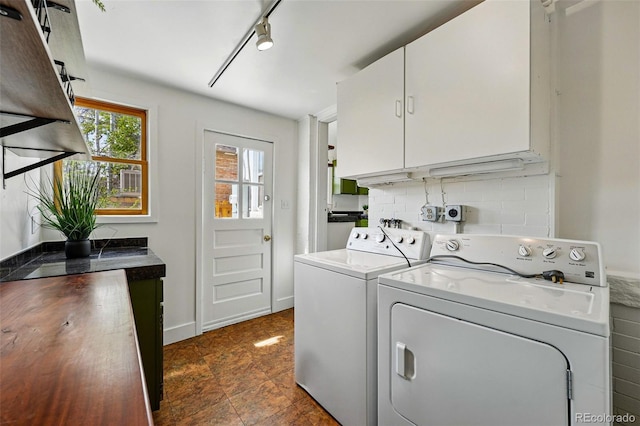 laundry room featuring cabinet space, independent washer and dryer, and track lighting