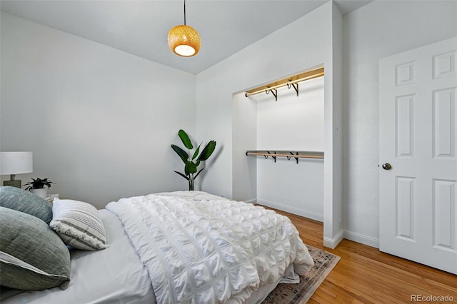bedroom featuring baseboards and light wood-style flooring
