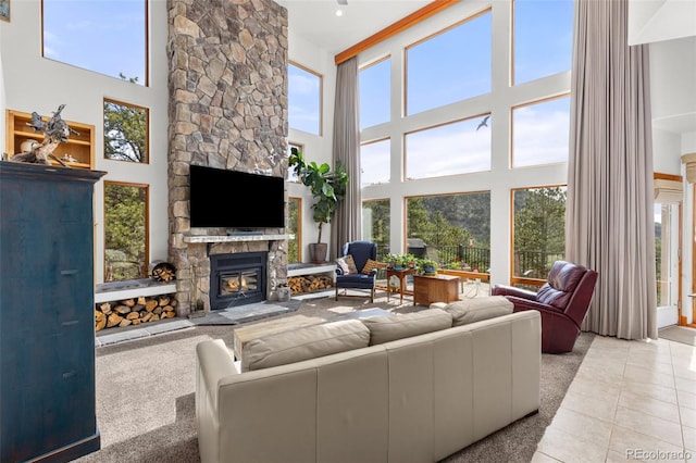729 Sawmill Rd, Loveland, CO 80537 - living room featuring a towering ceiling, plenty of natural light, a fireplace, and light tile patterned floors