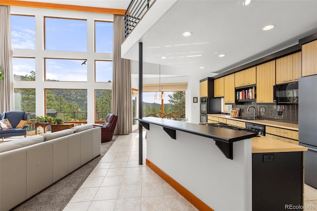 729 Sawmill Rd, Loveland, CO 80537 - kitchen featuring black appliances, light tile patterned floors, a sink, open floor plan, and recessed lighting