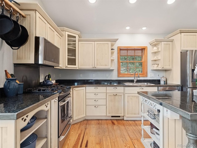 27905 Mariposa Rd, Evergreen, CO 80439 - kitchen featuring cream cabinets, stainless steel appliances, open shelves, and a sink