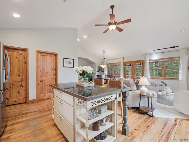 27905 Mariposa Rd, Evergreen, CO 80439 - kitchen with open shelves, ceiling fan, light wood-type flooring, stainless steel refrigerator with ice dispenser, and vaulted ceiling