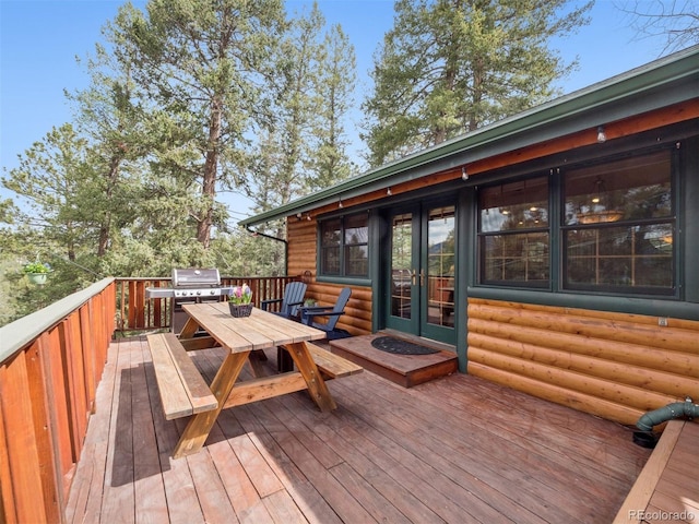 27905 Mariposa Rd, Evergreen, CO 80439 - wooden terrace featuring outdoor dining space, french doors, and area for grilling