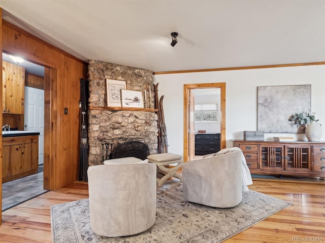 27905 Mariposa Rd, Evergreen, CO 80439 - living room with crown molding, wood walls, and wood finished floors