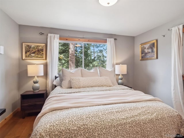 27905 Mariposa Rd, Evergreen, CO 80439 - bedroom with baseboards and wood finished floors